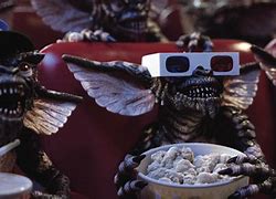 Gremlins watching a movie